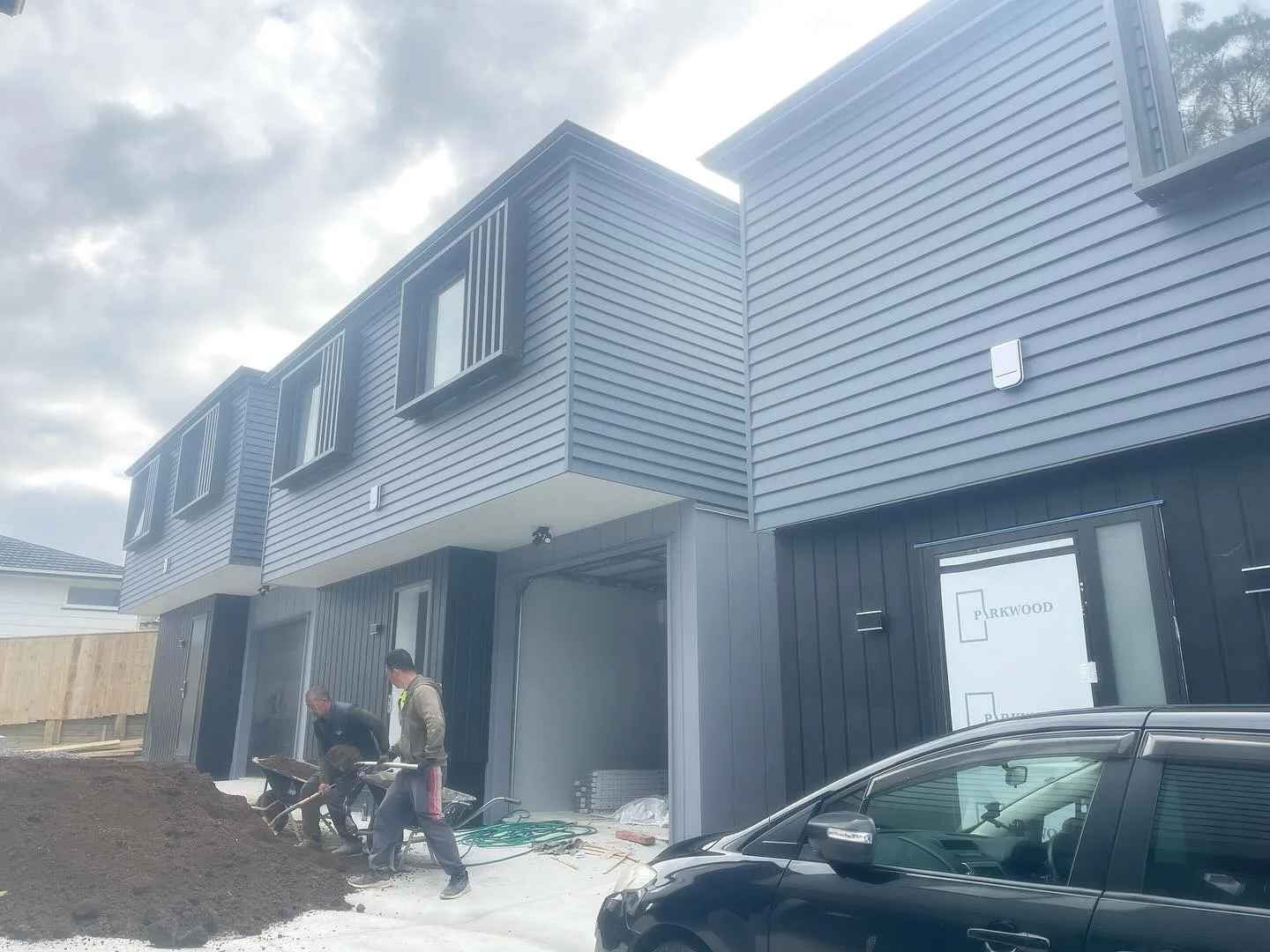 Townhouse exteriors with dark weatherboards and light trim