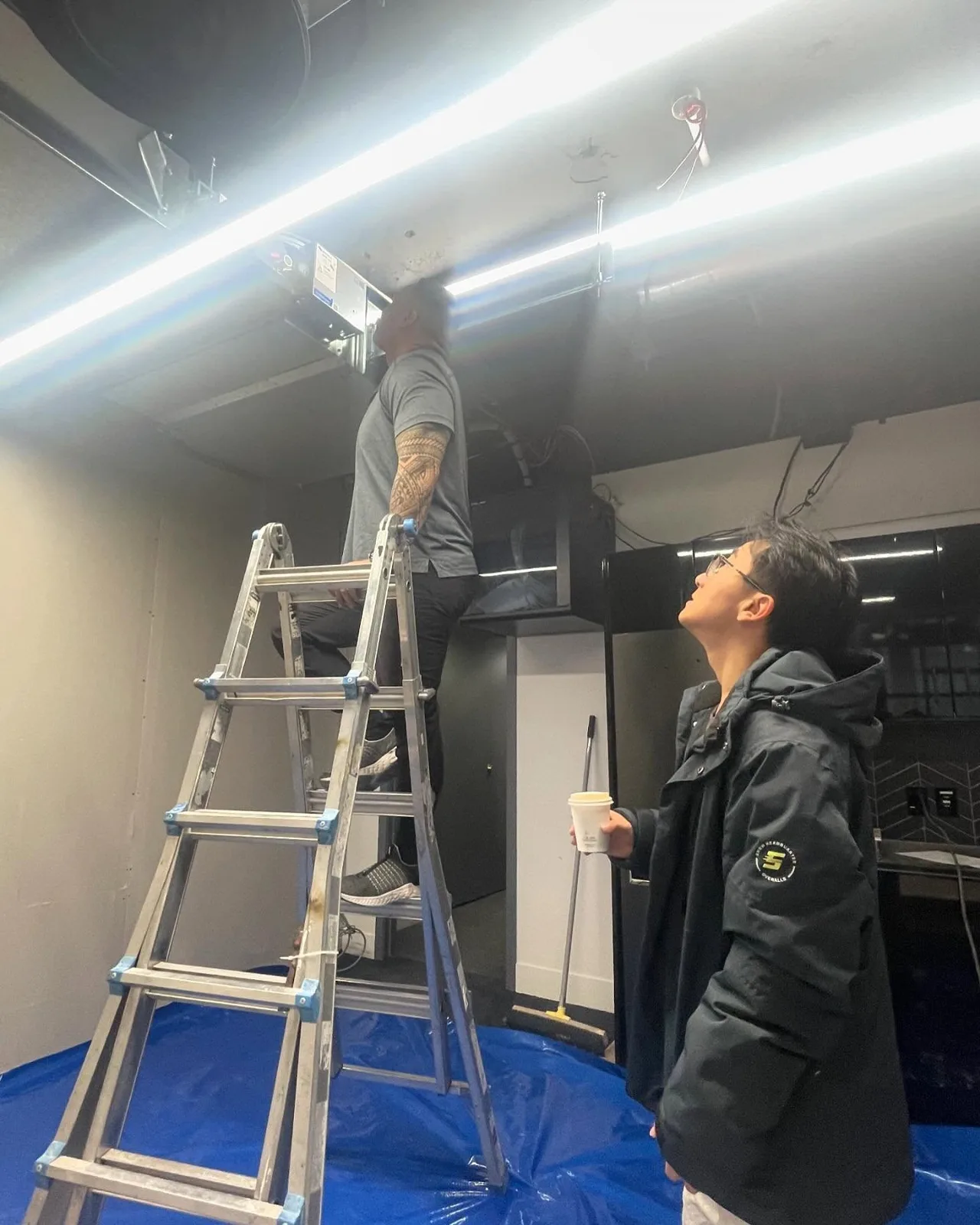 Interior ceiling preparation with ladders and protective coverings